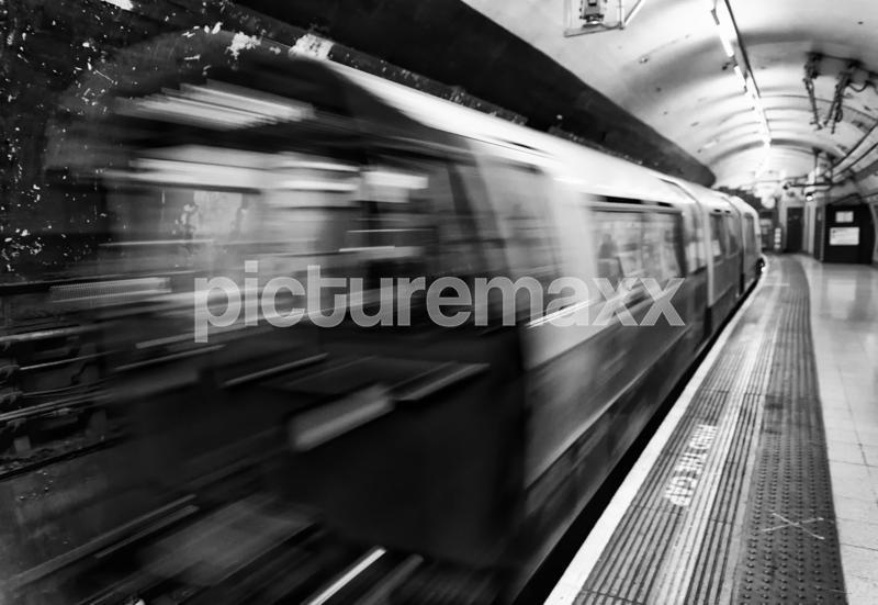 Train speeding up in city subway.