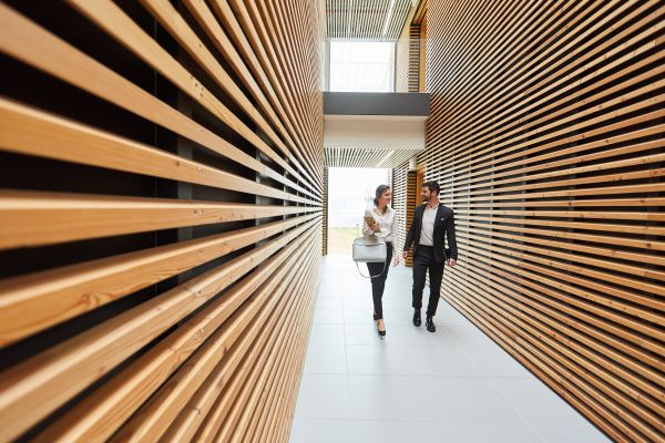 Two business people talking in a modern office building