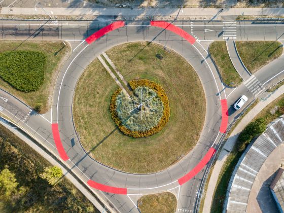 Aerial drone view. Roundabout with red bicycle markings.