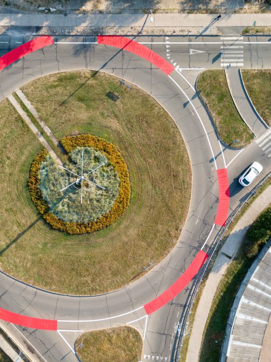 Aerial drone view. Roundabout with red bicycle markings.