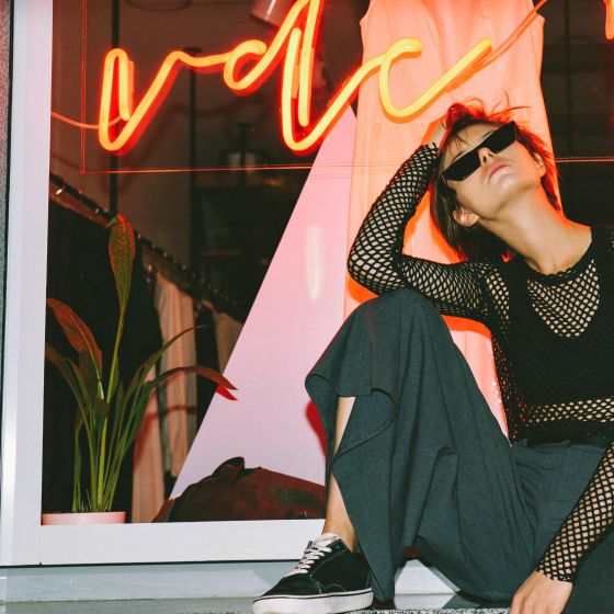 Pretty model advertise trendy clothing big shop window background