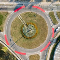 Aerial drone view. Roundabout with red bicycle markings.